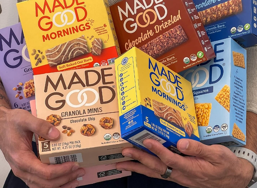 A close up of various MadeGood boxes held in the arms of a person. A close up of various MadeGood boxes held in the arms of a person.