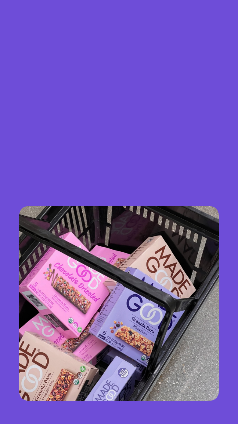 A variety of MadeGood boxed products are placed in a black shopping cart. A variety of MadeGood boxed products are placed in a black shopping cart.