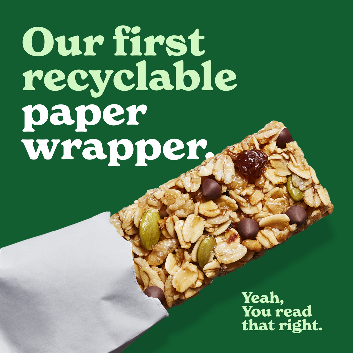 Granola bar partially unwrapped in a white, recyclable paper on a green background. Text reads, "Our first recyclable paper wrapper. Yeah, You read that right."