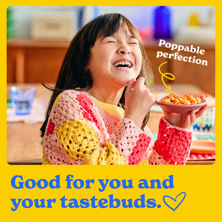 Good for you and your tastebuds: a child happily eating star puffed crackers