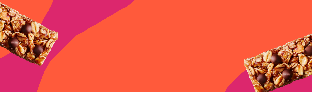 Two granola bars on a vibrant orange and pink abstract background