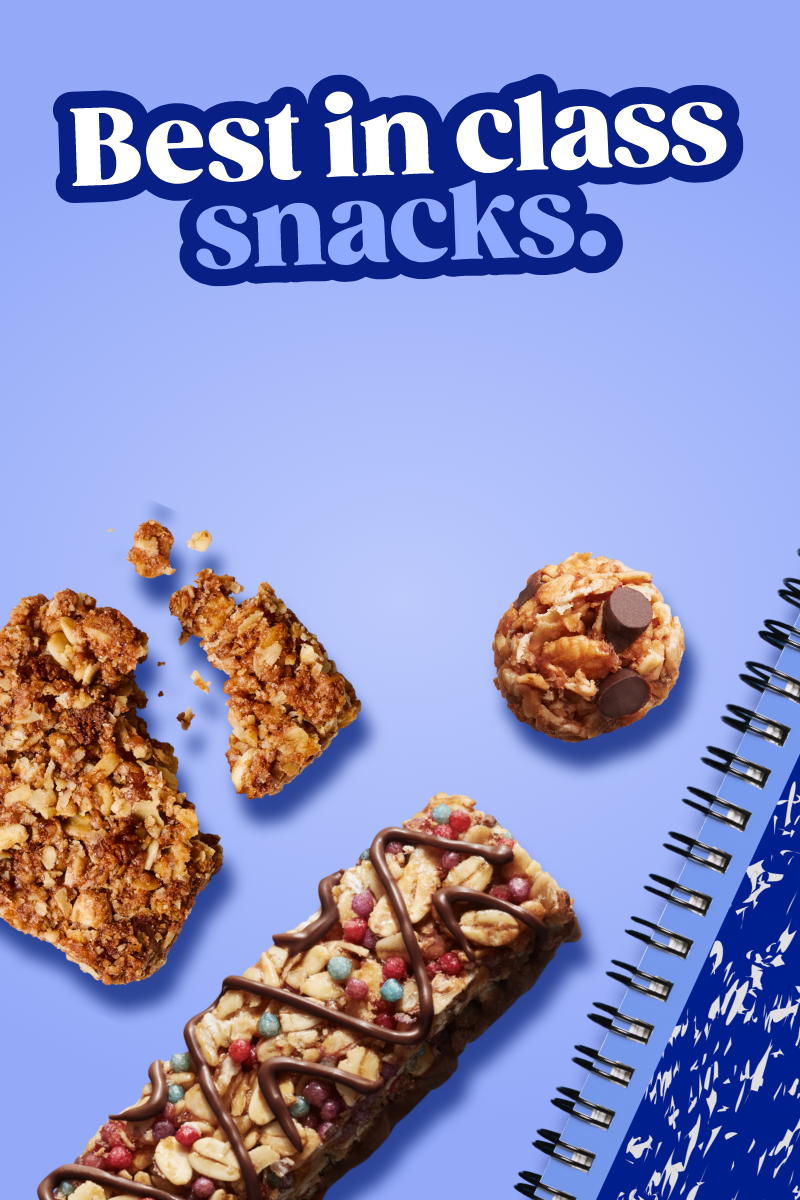 A MadeGood bar piece with oats and dark chocolate in it on a blue background