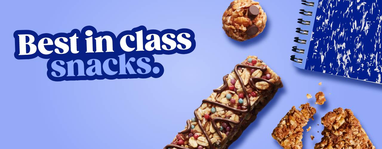 A MadeGood bar piece with oats and dark chocolate in it on a blue background