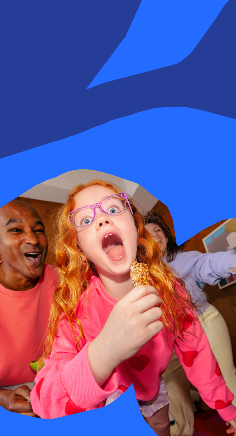 Mobile version of an image of a joyful family moment with a young girl enjoying a MadeGood snack bar, surrounded by bright playful colors.